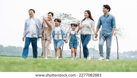 Asian family photo walking together in the park Royalty-Free Stock Photo #2277082881