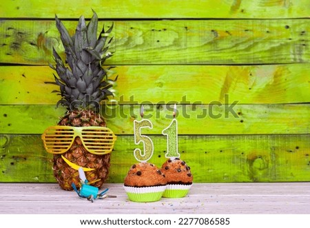 Creative card postcard happy birthday with number  51. Background character pineapple in festive glasses. Copy space anniversary card on yellow colorful wooden background. Royalty-Free Stock Photo #2277086585