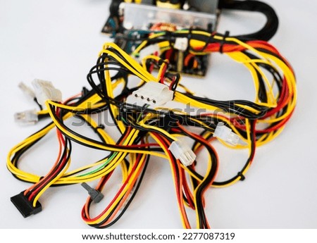 Multi-colored computer wires with white connectors on a white background. Connector, pin wired plug