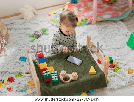 Young child playing with mobile phone. Young kid phone addiction.