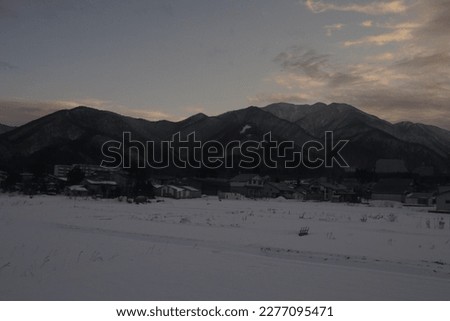 Beautiful Rural Sunset Shining on Snowy Landscape