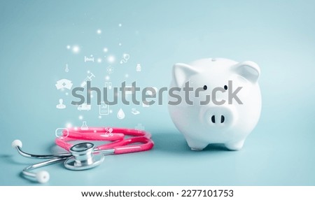 Piggy bank with stethoscope. saving money to health check insurance concept. Health care financial checkup and saving for medical insurance cost planning in the future. Royalty-Free Stock Photo #2277101753