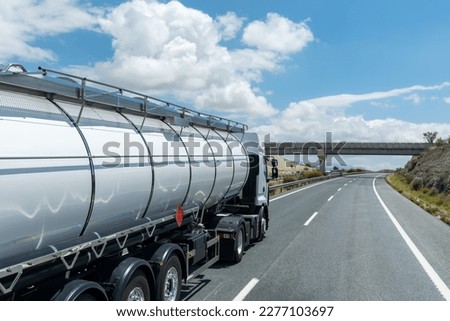 Tank truck with dangerous goods, danger from flammable liquids, driving on the highway. Royalty-Free Stock Photo #2277103697