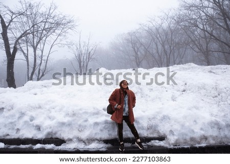 Traveler thai women people travel visit and posing portrait for take photo snow fall covered in forest on Hanla Mountain volcano or Mount Halla in Hallasan National Park at Jeju in Jeju do South Korea