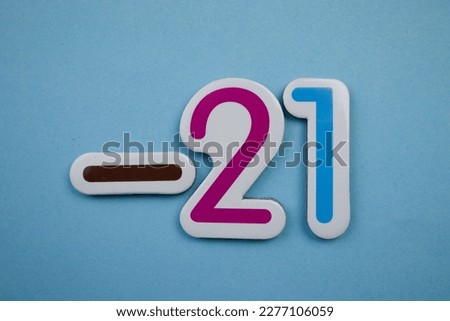 -21 is a colorful photo of -21 from the top, overlaid on a blue background.