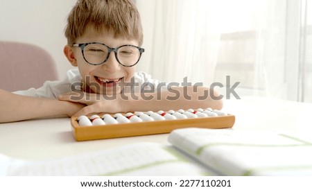 the child is engaged in mental arithmetic on the abacus, the concept of modern education. High quality photo