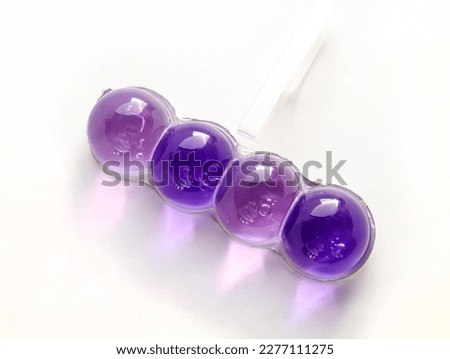 Colored balls for the toilet on a white background. Toilet block made of gel that is attached under the rim of the toilet bowl. hanging interchangeable balls and blocks with gel filling for the toilet Royalty-Free Stock Photo #2277111275