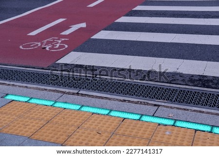 Street crossing in Seoul. The green light on the floor indicates that people can walk across.