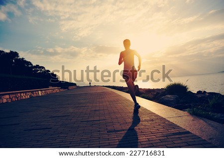Runner athlete running at seaside. woman fitness silhouette sunrise jogging workout wellness concept.  Royalty-Free Stock Photo #227716831