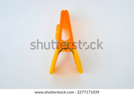 orange clothespins on a white background