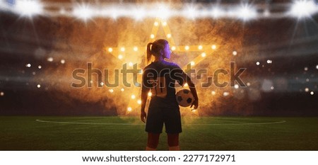  Portrait of young female soccer player with soccer ball standing with a shining star in the back Royalty-Free Stock Photo #2277172971