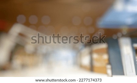 Abstract blurred background of shopping mall interior with crowd of shoppers enjoying and relaxing