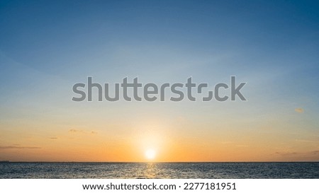 Sunset Sky Clouds in the Evening with Golden hour sunlight, Dusk sky Dark Blue Background on Landscape Horizon Sea and Sundown Royalty-Free Stock Photo #2277181951