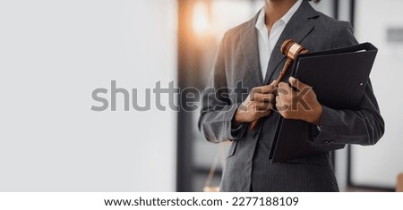 Lawyer woman holding a law hammer, concepts of law and legal services, law contract.