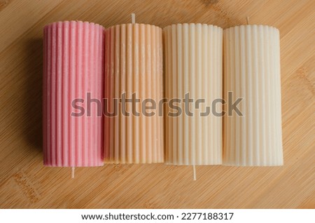 A cylindrical candle made of soy wax. Colour background Royalty-Free Stock Photo #2277188317