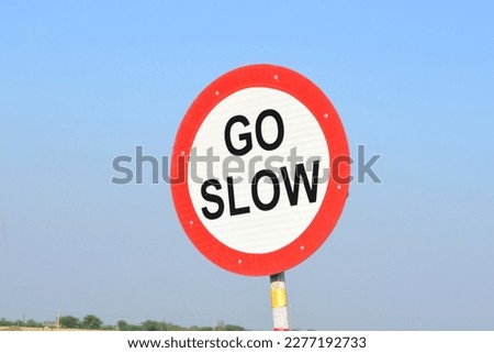 Red sign warning symbol on highway road and go slow isolated