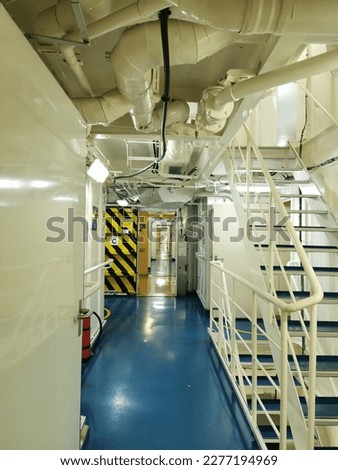 Vessel's ( ship ) watertight doors  in a crew corridor open.