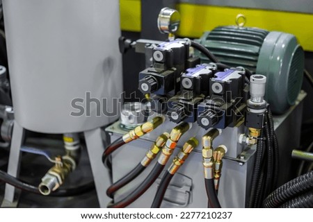 Part of automatic injection molding machine and flexible plastic hoses at exhibition, trade show. Manufacturing, production, technology concept Royalty-Free Stock Photo #2277210237