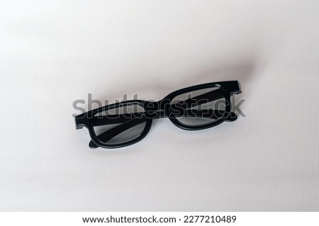 black plastic glasses for watching stereo films in a cinema. on a white background. view from above.