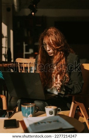 Front view photo of lovely ginger female worker wondering how she did a mistake at her daily tasks while working remotely