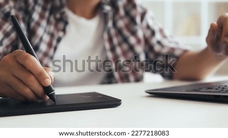 Graphic designer. Digital drawing. Creative occupation. Unrecognizable man illustrator artist working sketching using tablet stylus at blur workplace with free space.