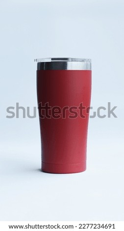 Red stainless steel tumbler and mug vacuum insulated double wall travel cup with lid isolated on white. Royalty-Free Stock Photo #2277234691