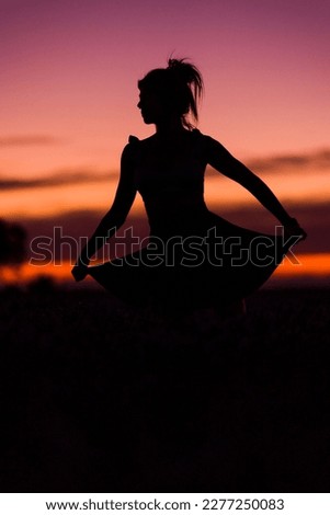 woman silhouette in nature field. summer, spring background with energy. Health balance lifestyle