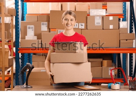 Post office worker with parcels and clipboard near rack indoors Royalty-Free Stock Photo #2277262635