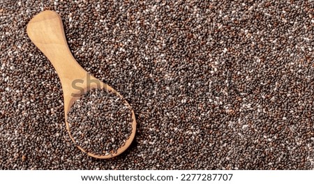 Chia seeds close-up with a wooden spoon. Chia seeds macro. Dry healthy supplement for proper nutrition. Royalty-Free Stock Photo #2277287707