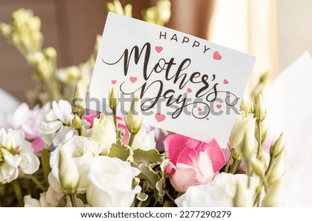 flower composition of light roses and eustoma closeup. Text Happy mother's day. Bright bouquet with tender flowers.Greetings card,sweet wish concept. Royalty-Free Stock Photo #2277290279