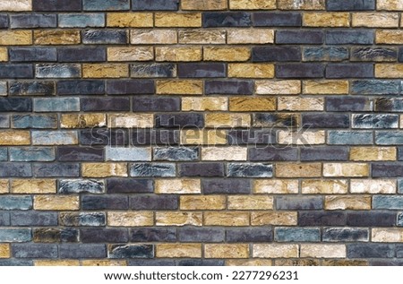 The texture of the wall from the new gray-yellow bricks. Background and texture.