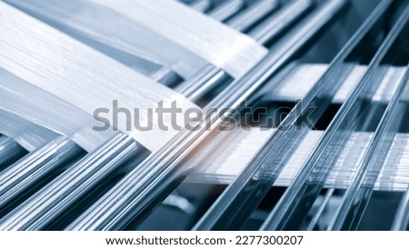 synthetic textile thread,  thread at industrial weaving manufacturing machine,  textile fabric production industrial concept background Royalty-Free Stock Photo #2277300207