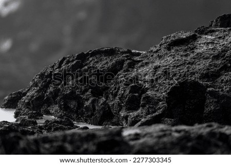 Very big and beautiful black rocks the power of the ocean close up of black lava stones Royalty-Free Stock Photo #2277303345