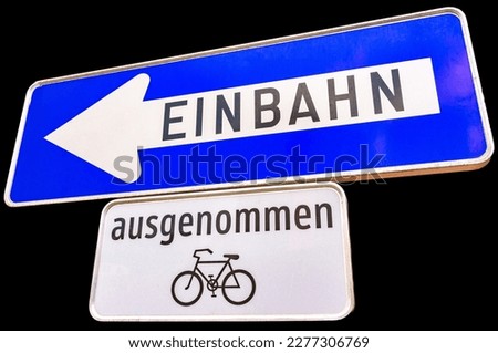 blue street sign in Austria with the German word for oneway on it an excluding bicycles, black background