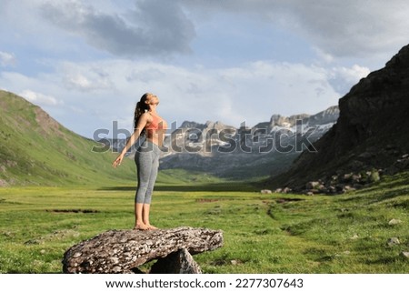 Full body portrait of a sportswoman breathing fresh air in a beautiful mountain Royalty-Free Stock Photo #2277307643