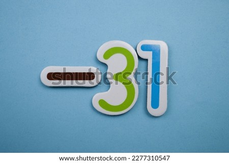 -31 is a colorful photo of -31, taken from above, over a blue background.
