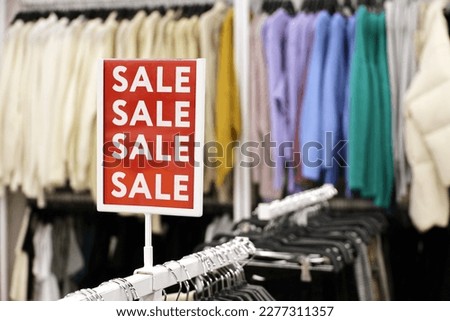 Sale signs with discounts in a clothing store. Concept of retail sales and shopping