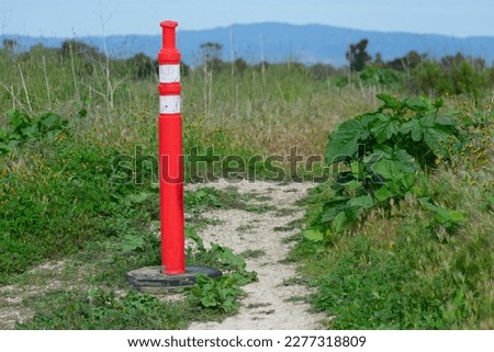 An orange caution cone closing off a trail due to inclement weather in Southern California