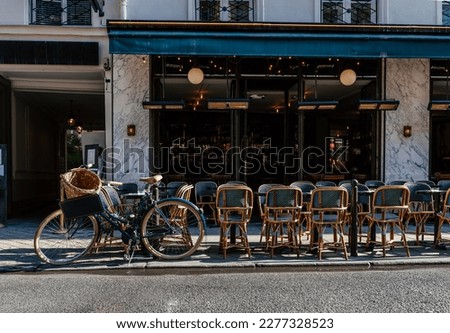 Cozy street with tables of cafe  in Paris, France. Cityscape of Paris. Architecture and landmarks of Paris Royalty-Free Stock Photo #2277328523