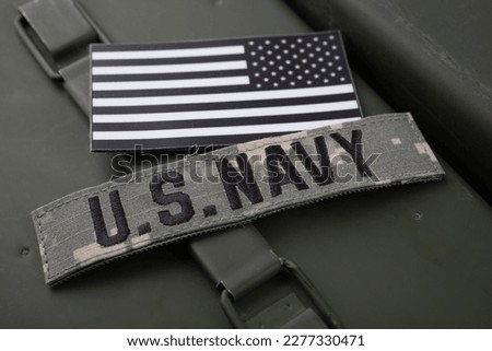 U.S. Navy Branch Tape with national US flag patch on green ammo can background Royalty-Free Stock Photo #2277330471