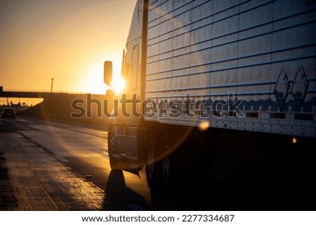 Long Haul 18 Wheel Truck at sunrise or sunset  Royalty-Free Stock Photo #2277334687
