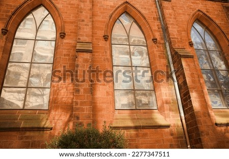 historic brick building structure with glass windows of urban arpartment building old residential construction in boston downtown street with blue sky and business concept symbolizing monotonous work