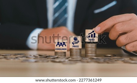 Businessman touching wooden blocks with icons. Words Consumer, Price, Index. CPI on available batteries, load options and CPI and CPI. Royalty-Free Stock Photo #2277361249