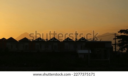 Evening sun setting on a row of suburban houses in a subdivision