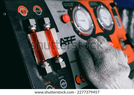 Car automatic transmission fluid flushing service in garage shop. Royalty-Free Stock Photo #2277379457