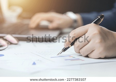 Male hand doing accounting, calculating bills, and expenses at home. Family budget bill payment checklist concept, pay bill check, income allocation plan, or Family budget hedge plan. Royalty-Free Stock Photo #2277383107