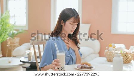 asian woman eat high sugar content food and has Gastroesophageal Reflux Disease feel uncomfortable Royalty-Free Stock Photo #2277392295