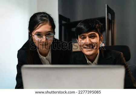 Couple two business man and woman working late at night. Discussion in office working with laptop. Boss and employee