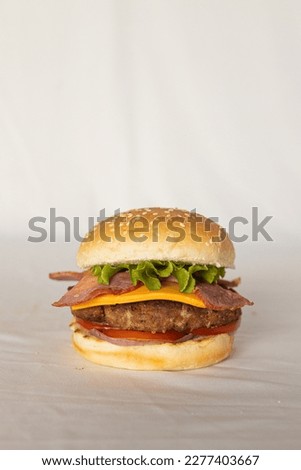 Burgers in front of solid background