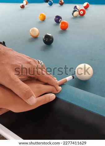 instructor and student hands holding billiard cues. hold a strong and purposeful billiard cue. follow my guide. so more or less an instructor teaches his students.